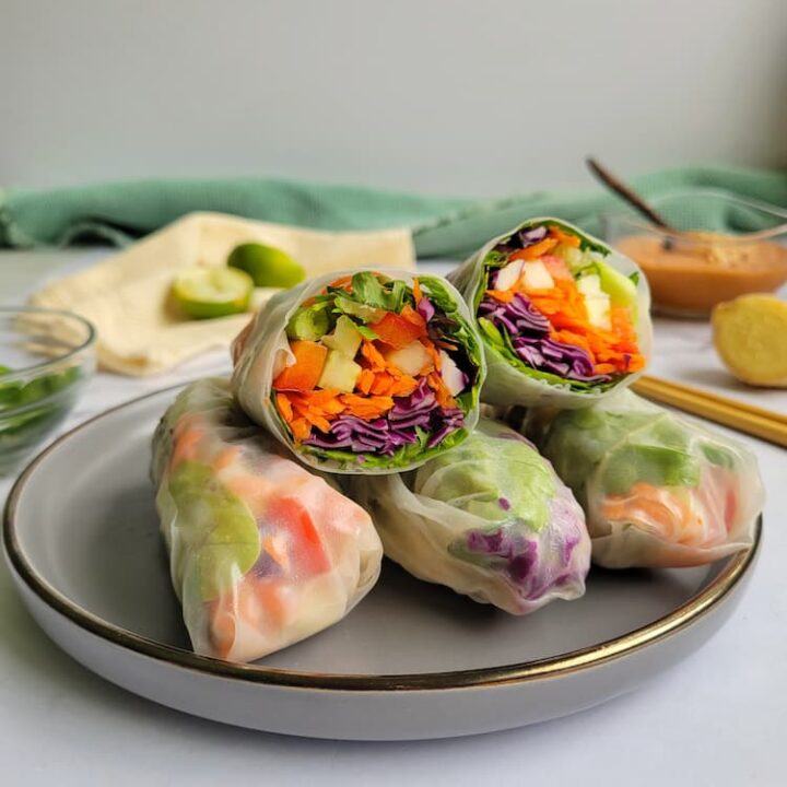 plate with fresh veggie spring rolls, top one cut in half