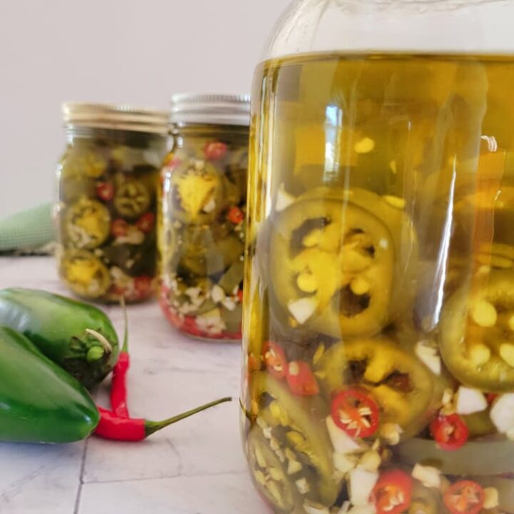 3 jars of jalapeños, thai red chilies and minced garlic in olive oil