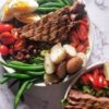 LOW FODMAP TWIST ON THE CLASSIC FRENCH NIÇOISE SALAD WITH EGG, POTATOES, OLIVES, GREEN BEANS AND TOMATOES