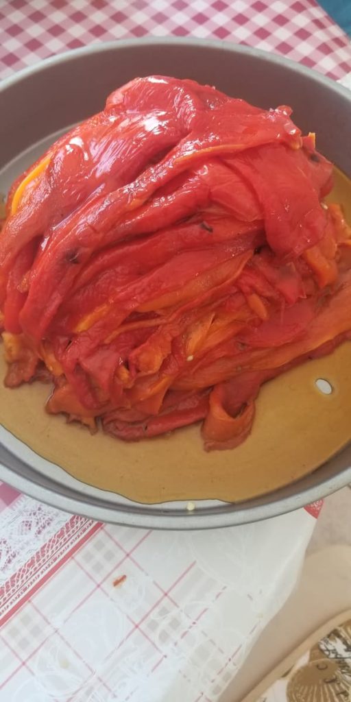 big pile of roasted red peppers in their juices