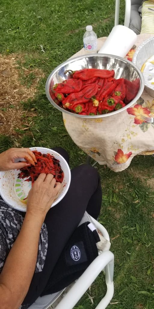mom separating roasted red pepper peels from roasted red peppers