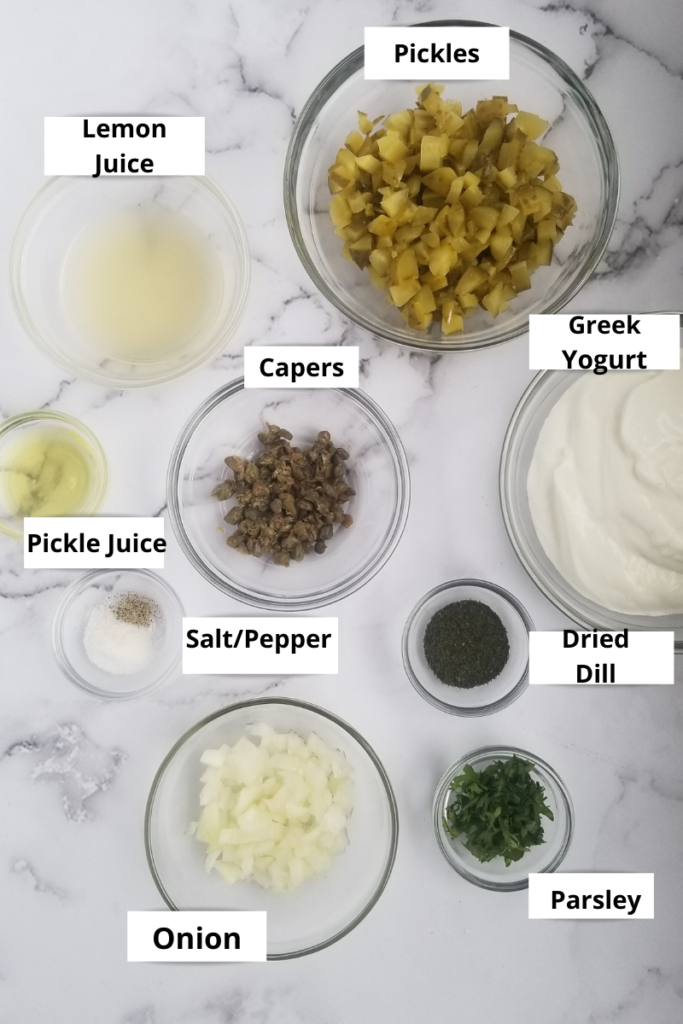 ingredients to make quick tartar sauce - diced pickles, pickle juice, lemon juice, salt and pepper, minced capers, minced onion, chopped parsley, dried dill and greek yogurt