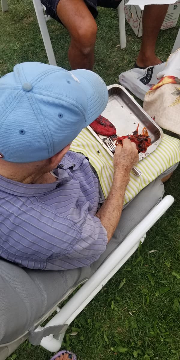 grandfather separating peels from roasted red peppers