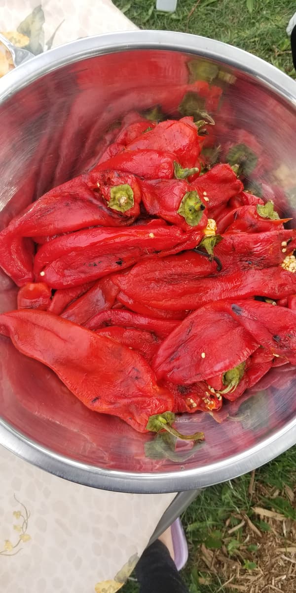 big bowl of peeled fresh roasted whole red peppers