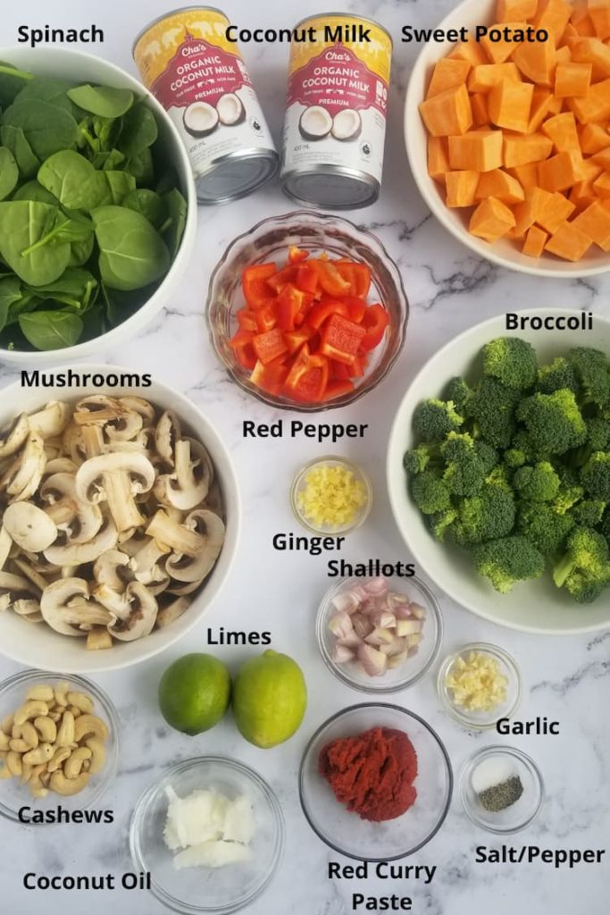Ingredients for sweet potato curry - sweet potatoes, broccoli, red peppers, spinach, mushrooms, shallots, ginger, garlic, salt and pepper, red curry paste, cashews, coconut oil, coconut milk, limes