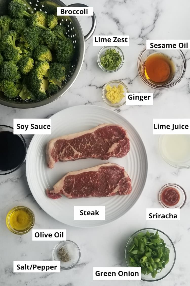 ingredients to make low fodmap beef and broccoli - broccoli, lime zest, garlic, sesame oil, soy sauce, steak, lime juice, sriracha, green onion, salt and pepper and olive oil