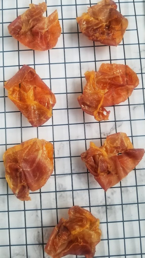 7 pieces of crispy prosciutto on a wire rack