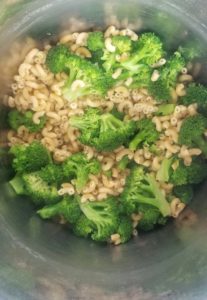 silver pot with elbow macaroni and broccoli florets