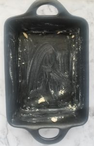 black cast iron rectangular casserole buttered
