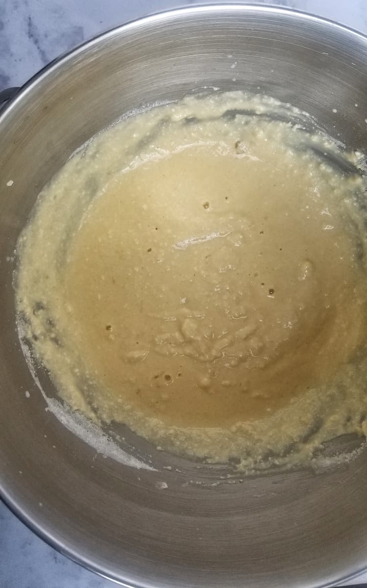 yellow batter in a silver bowl