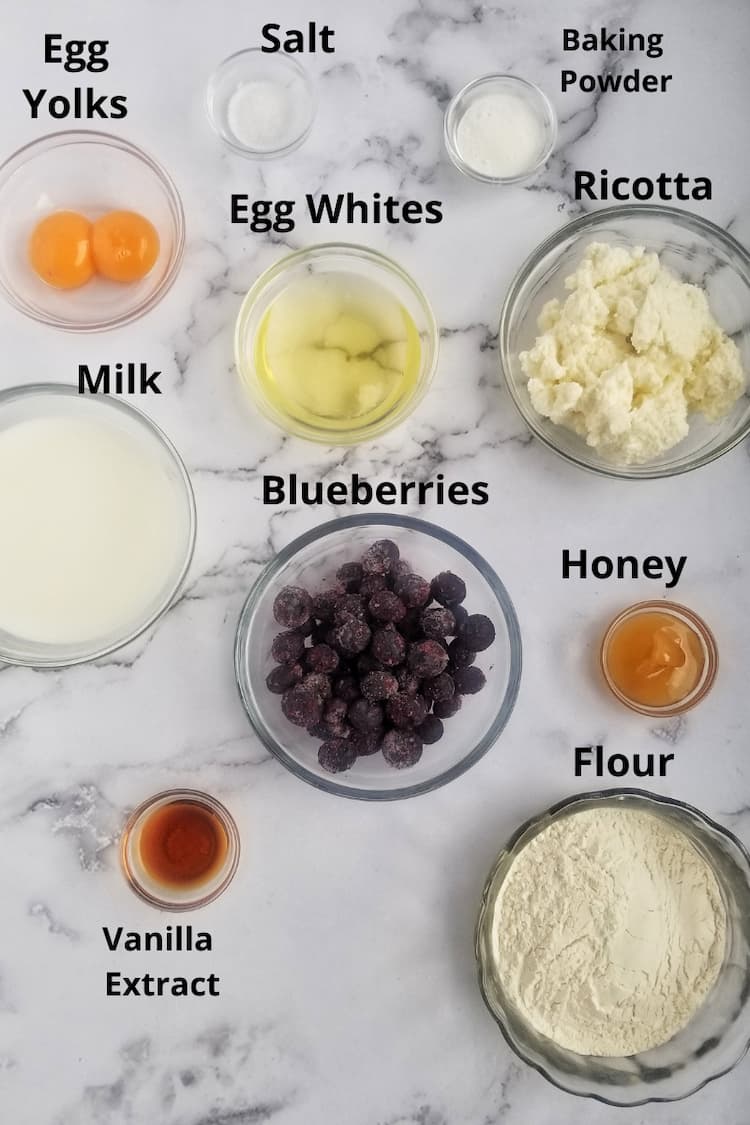 Ingredients for ricotta pancakes with blueberries - blueberries, flour, ricotta, egg yolks, egg whites, baking powder, salt, vanilla extract, milk and honey