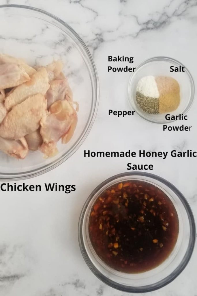 ingredients for honey garlic chicken wings - chicken wings, salt, pepper, baking powder, garlic powder, homemade honey garlic sauce