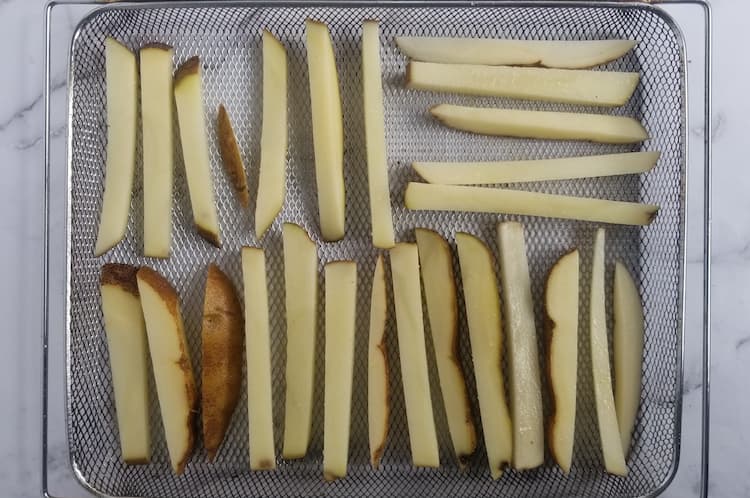 air fryer tray with homemade fresh cut french fries in a single layer