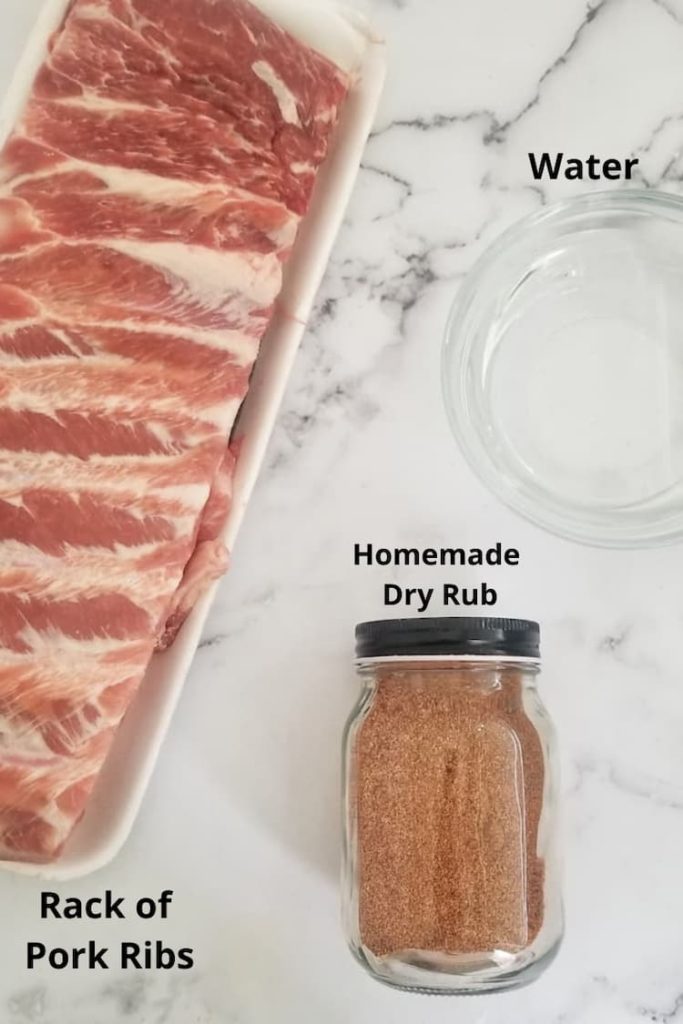 raw rab of ribs, dry spice in a glass jar and bowl of water