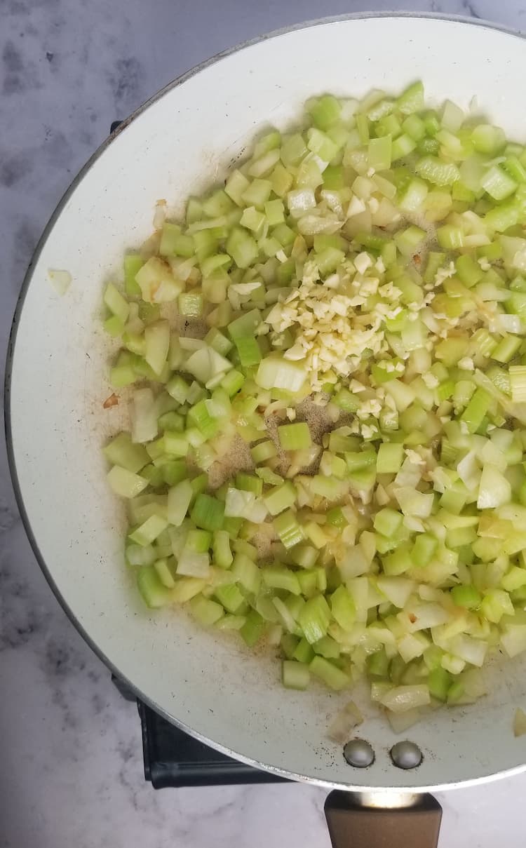 skillet with minced garlic, diced onions and diced celery