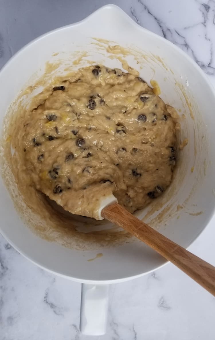 bowl and spatula with yellow batter and chocolate chips