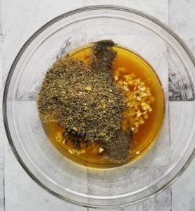 bowl of minced garlic, olive oil and spices