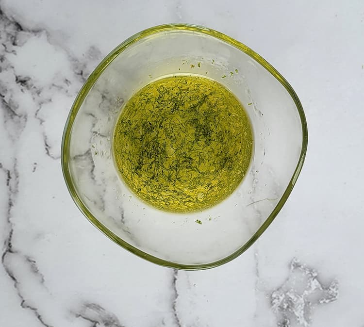 bowl of olive oil and fresh chopped dill