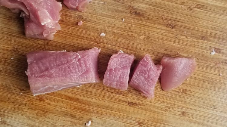 cutting board with pork chunks