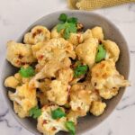 bowl of roasted cauliflower with chopped parsley