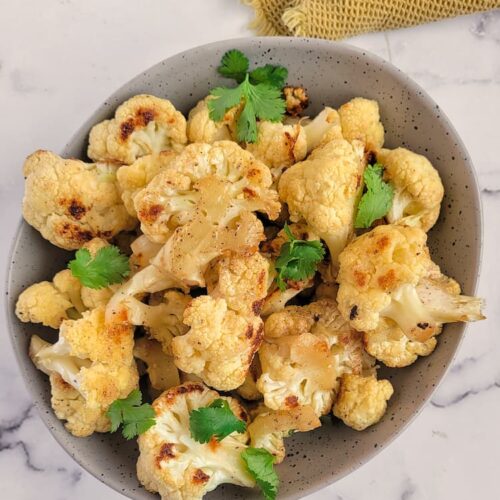 bowl of roasted cauliflower with chopped parsley