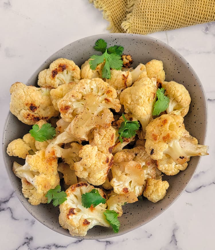 bowl of roasted cauliflower with chopped parsley