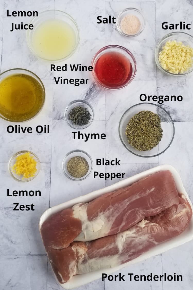 ingredients for pork souvlaki - pork tenderloin, minced garlic, salt, lemon juice, oregano, red wine vinegar, thyme, olive oil, lemon zest, black pepper