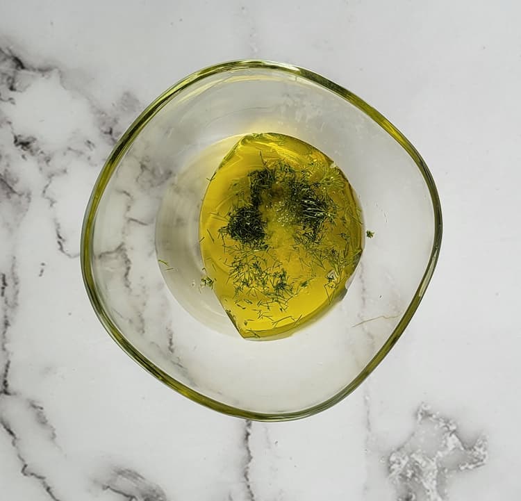 bowl of olive oil, fresh fill and white vinegar