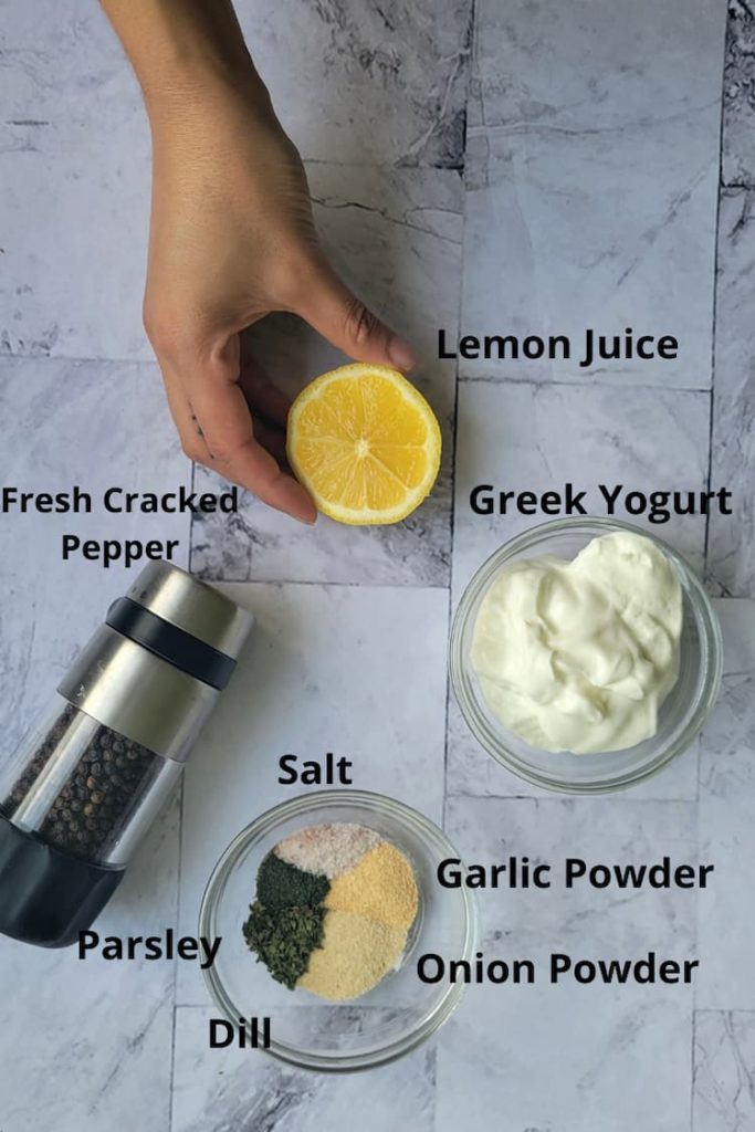 ingredients for recipe for homemade ranch dressing - lemon juice, salt, fresh cracked pepper, parsley, dill, garlic powder, onion powder, greek yogurt