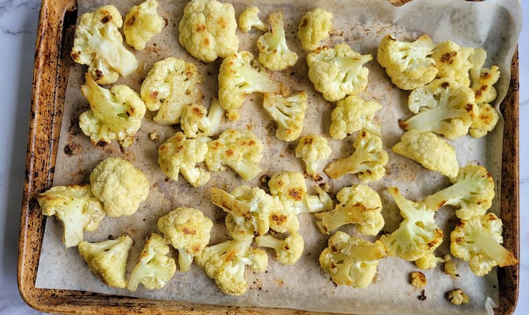 parchment lined baking sheet with roasted cauliflower