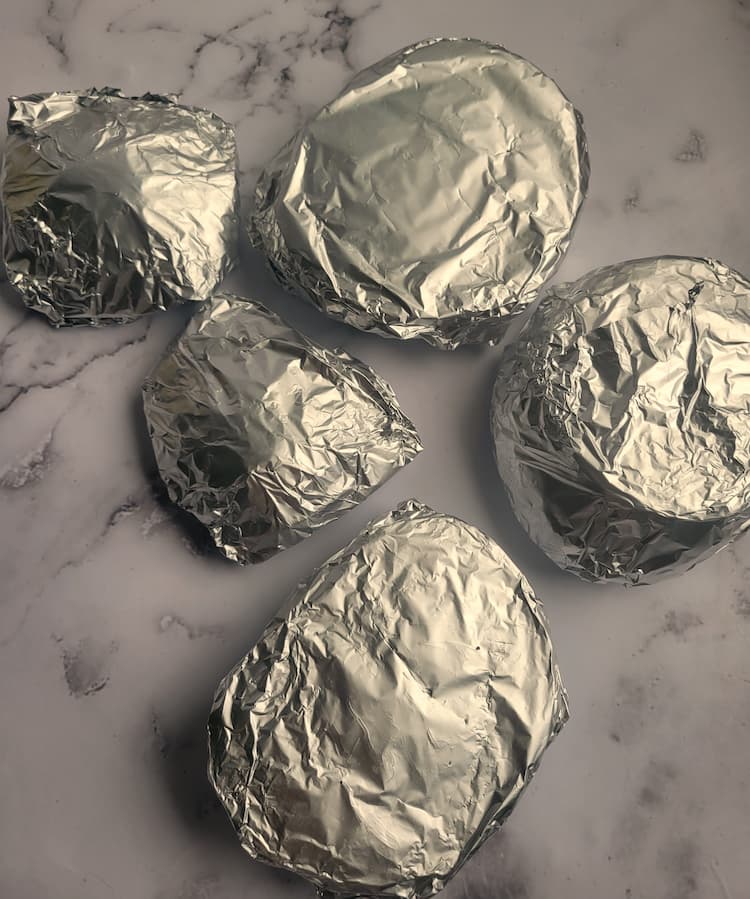 5 different sized cabbage steaks wrapped in foil