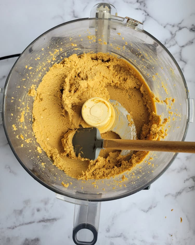 food processor with chickpea cookie dough and a mini spatula
