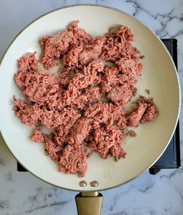 skillet with raw ground beef