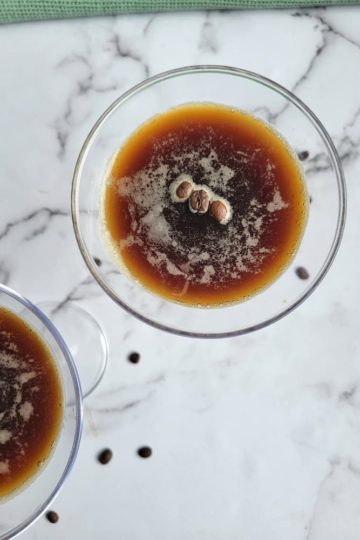 two espresso martinis with coffee beans