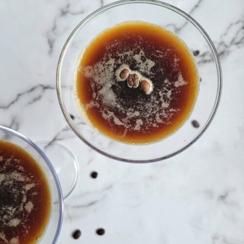 two espresso martinis with coffee beans