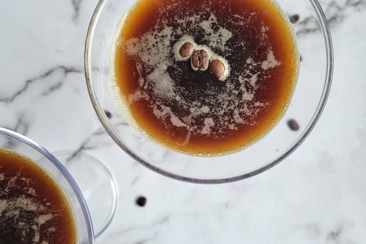 two espresso martinis with coffee beans