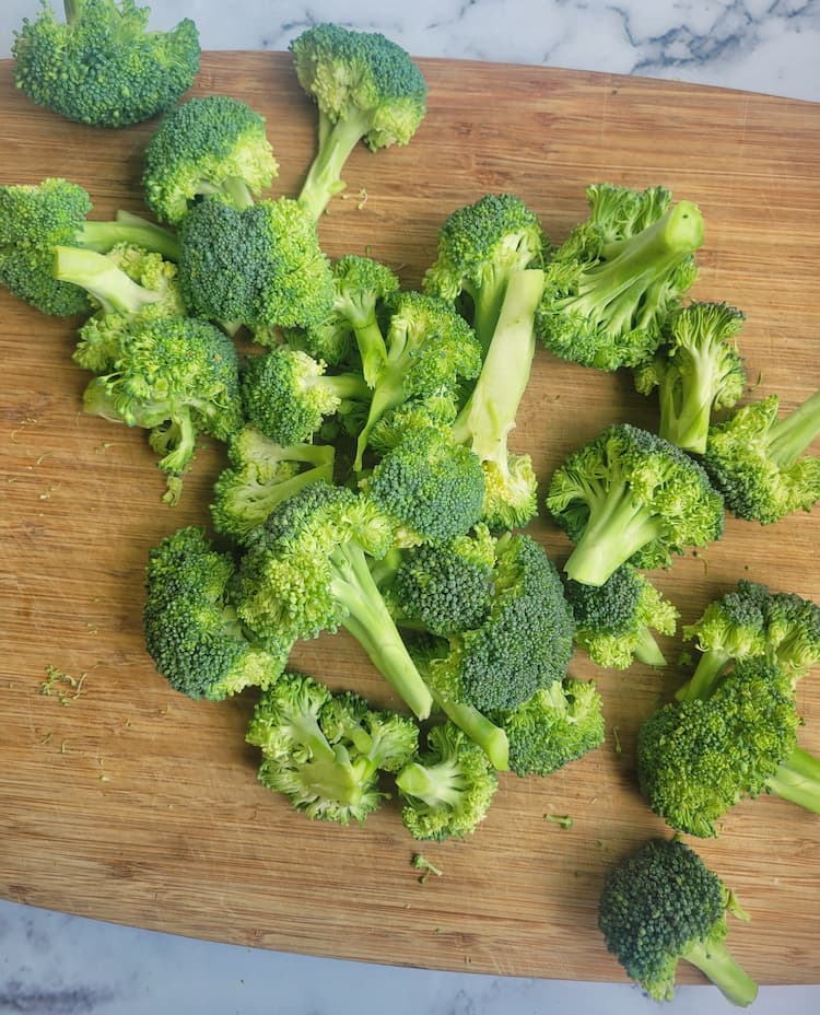 cutting board with broccoli florets