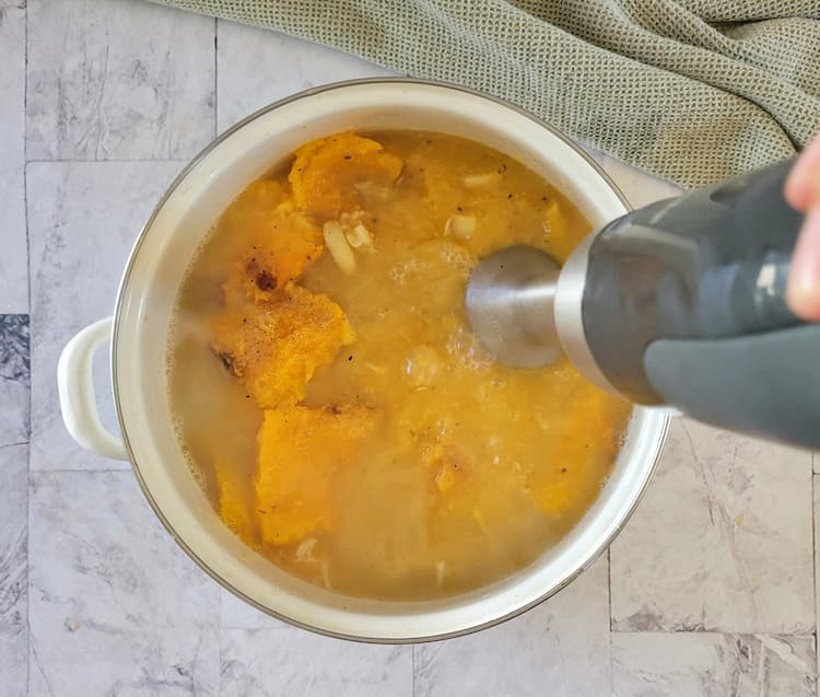 immersion blender in a half blended pot of butternut squash soup