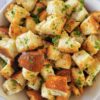close up of a bowl of croutons garnished with fresh chopped parsley