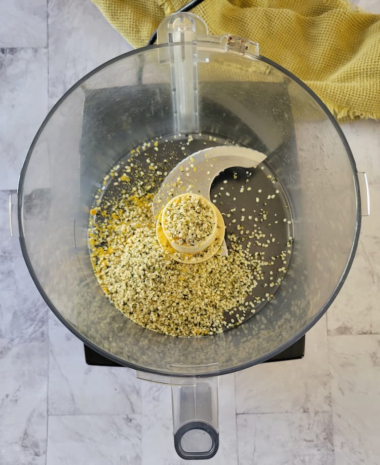 base of a food processor with hemp seeds and nutritional yeast