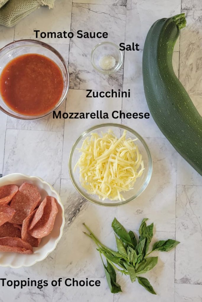 ingredients for zucchini pizza bites - zucchini, mozzarella cheese, tomato sauce, salt, toppings