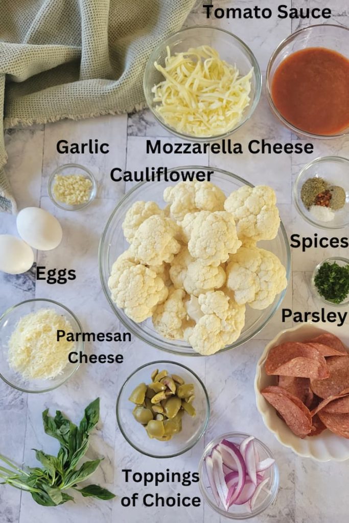 ingredients for recipe for cauliflower crust pizza - cauliflower, spices, parsley, toppings, parmesan cheese, eggs, mozzarella cheese, garlic, tomato sauce