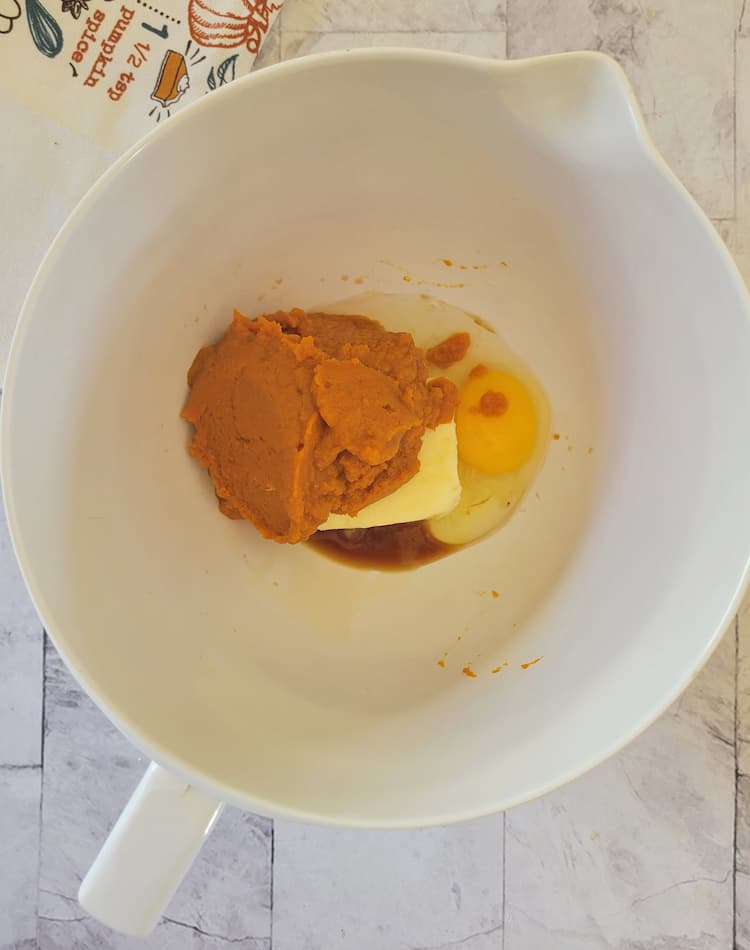 mixing bowl with pumpkin puree, egg, butter, vanilla