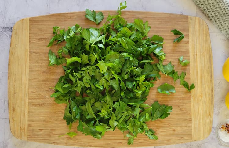 cutting board with fresh parsley leaves
