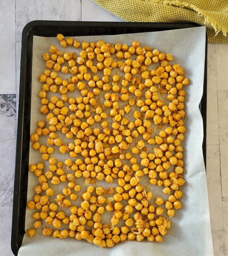 parchment lined baking sheet with roasted chickpeas