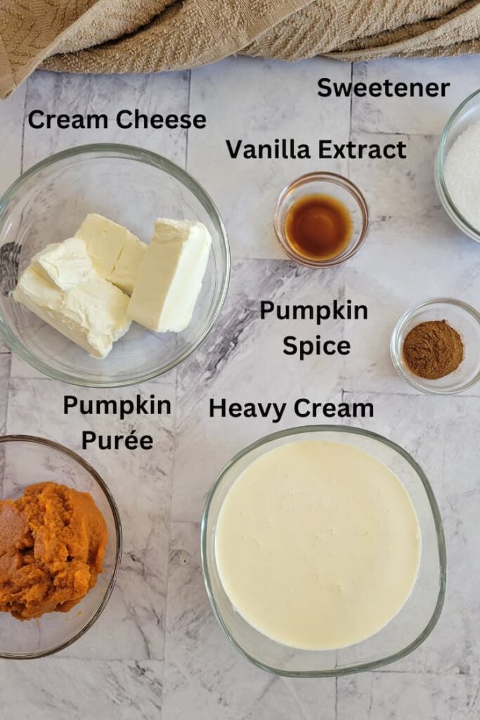 ingredients for recipe for pumpkin mousse - pumpkin puree, heavy cream, cream cheese, vanilla extract, pumpkin spice, sweetener