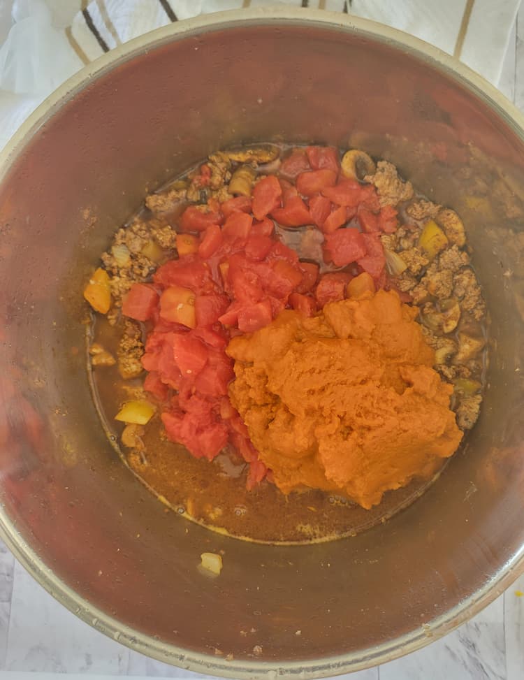 pot of ground beef and turkey, diced tomatoes and pumpkin purée, unmixed