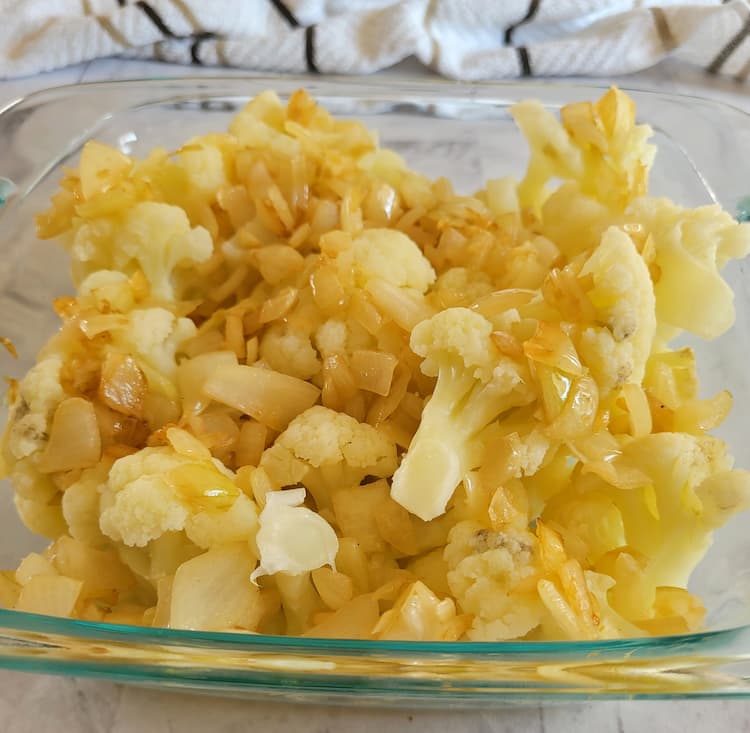 cooked cauliflower florets and diced onion in a small glass baking dish