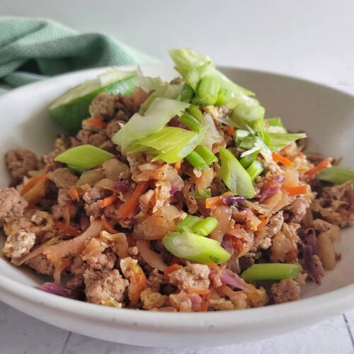 keto egg roll in a bowl topped with green onions