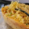 side view of cooked spaghetti squash garnished with parsley